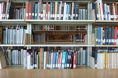 Photo of books on shelves at a library